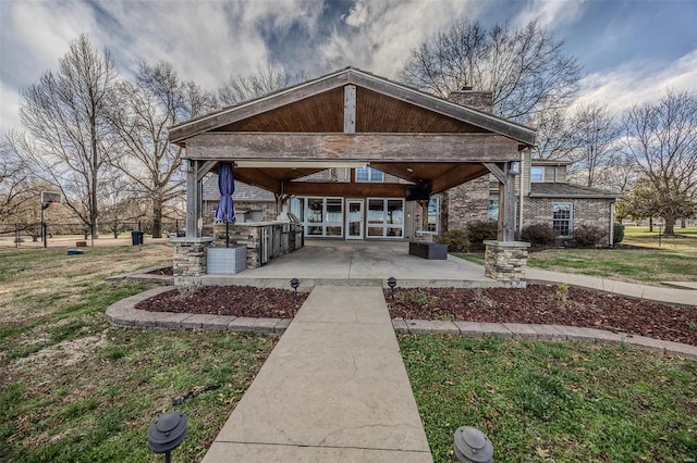 view of home's community featuring a lawn and a patio