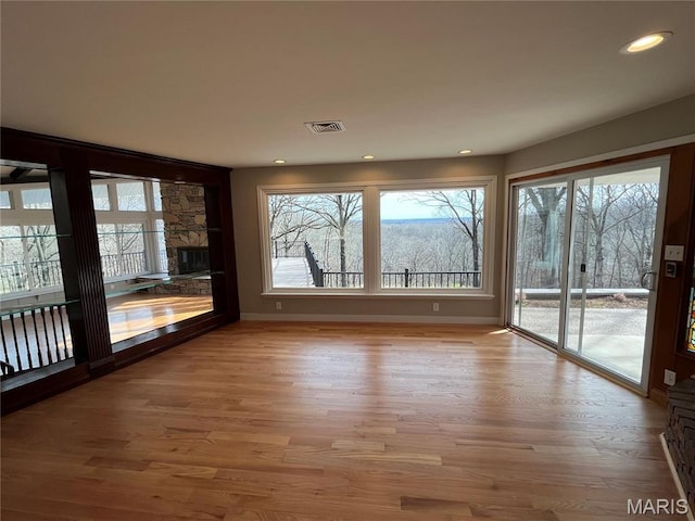 unfurnished dining area featuring wood finished floors, baseboards, and recessed lighting