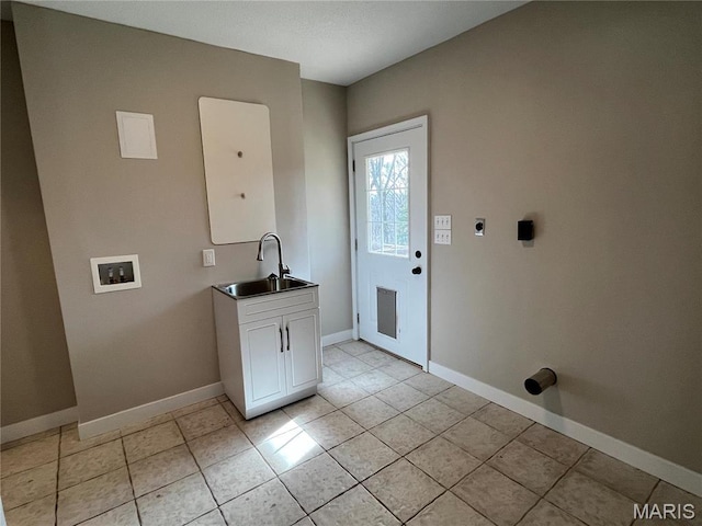 washroom featuring electric dryer hookup, washer hookup, baseboards, cabinet space, and light tile patterned flooring