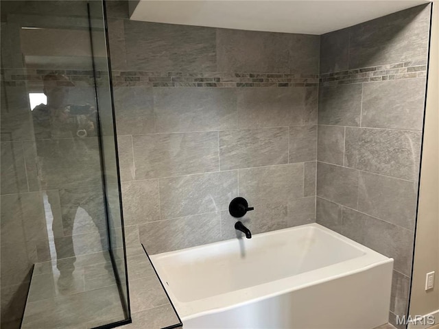bathroom with a tub to relax in and tiled shower