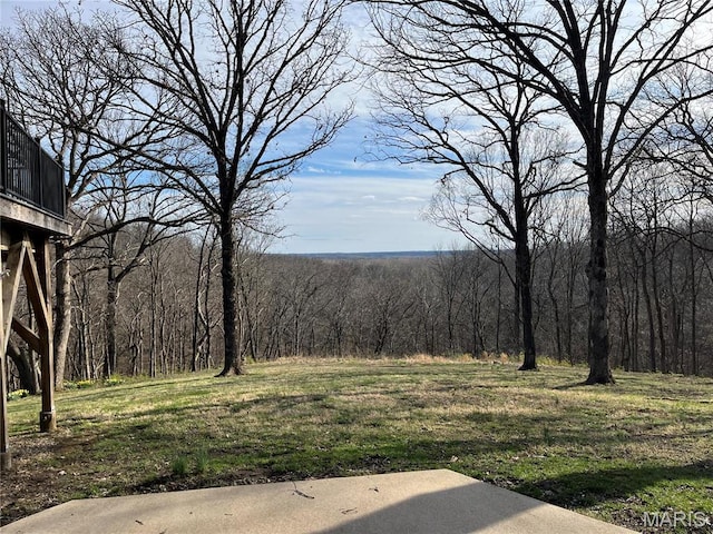 view of yard featuring a forest view