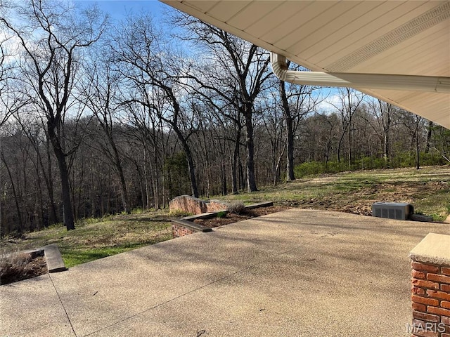 view of patio / terrace with a wooded view