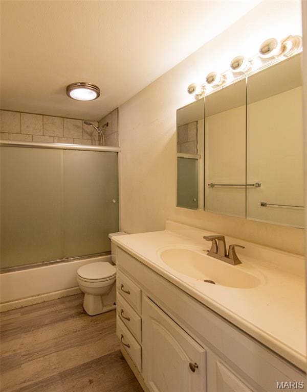 290 E Oak St, Saint Clair, MO 63077 - full bathroom with wood finished floors, vanity, combined bath / shower with glass door, and toilet