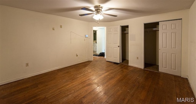290 E Oak St, Saint Clair, MO 63077 - unfurnished bedroom with dark wood-style flooring, multiple closets, and baseboards