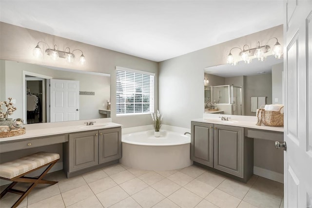 full bathroom featuring a stall shower, a bath, two vanities, and tile patterned floors