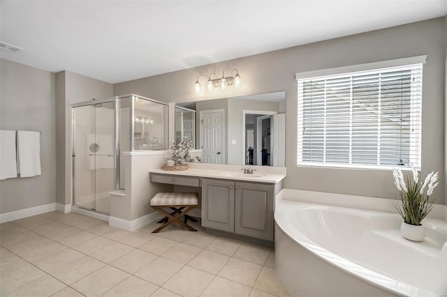 bathroom with a stall shower, tile patterned floors, vanity, a garden tub, and baseboards