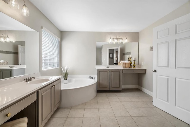 bathroom with a chandelier, a bath, tile patterned flooring, and two vanities