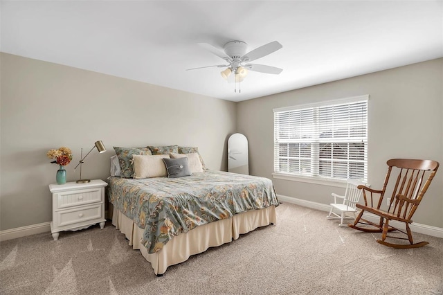 bedroom with baseboards, light colored carpet, and a ceiling fan