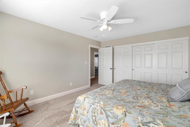carpeted bedroom with baseboards, a closet, and a ceiling fan