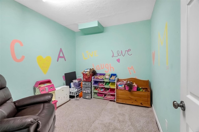 rec room with carpet floors, baseboards, and a textured ceiling