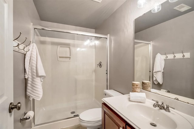 full bathroom featuring toilet, a shower stall, and vanity