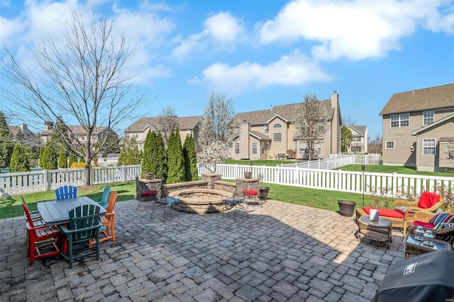 view of patio featuring a fire pit and a residential view
