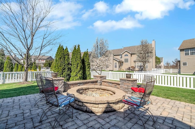 view of patio featuring an outdoor fire pit and a residential view