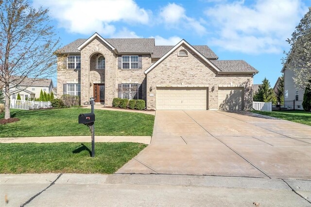 view of front of home with concrete driveway, a garage, a shingled roof, and brick siding