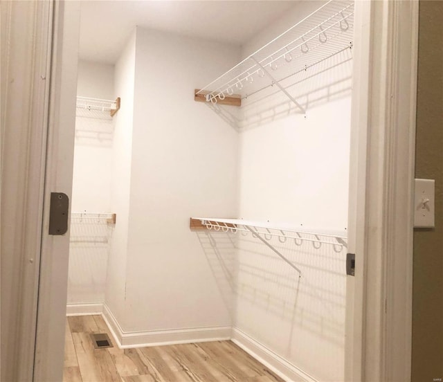 spacious closet featuring wood finished floors