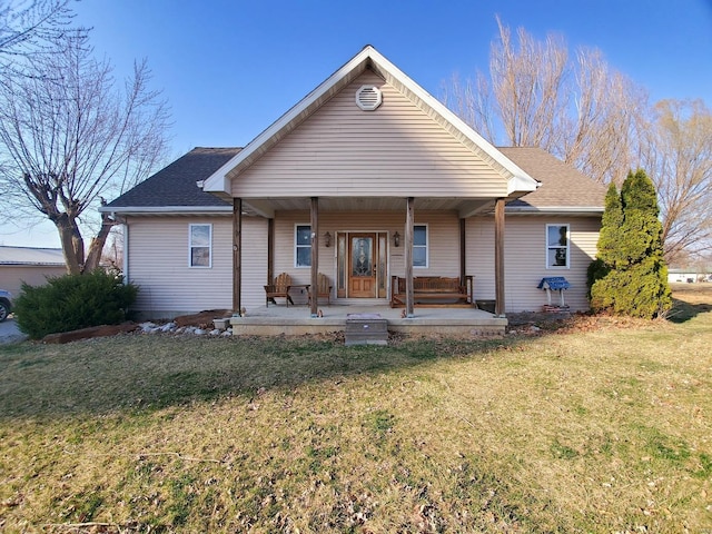 104 E Bryan St, Ewing, MO 63440 - rear view of property featuring a yard, covered porch, and a shingled roof
