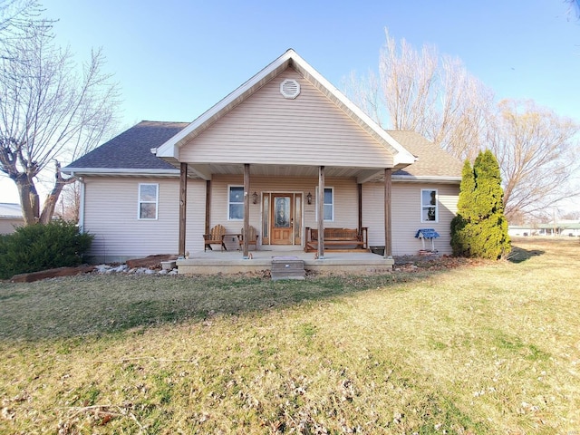 104 E Bryan St, Ewing, MO 63440 - rear view of house with a yard, covered porch, and a shingled roof
