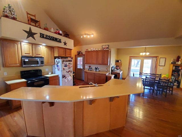 104 E Bryan St, Ewing, MO 63440 - kitchen featuring black range with electric stovetop, stainless steel microwave, freestanding refrigerator, a sink, and light countertops