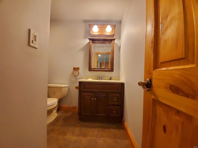 104 E Bryan St, Ewing, MO 63440 - bathroom featuring toilet, baseboards, and vanity