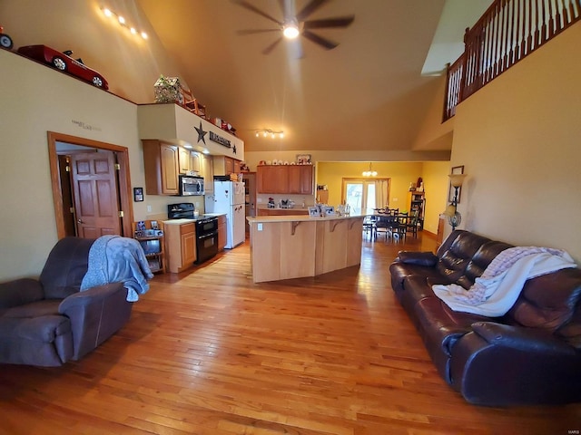 104 E Bryan St, Ewing, MO 63440 - living room with high vaulted ceiling, a ceiling fan, and light wood-style floors