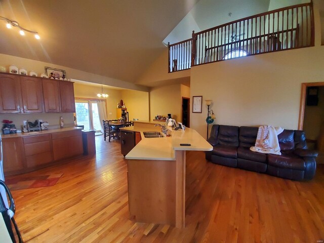 104 E Bryan St, Ewing, MO 63440 - kitchen with a sink, a chandelier, open floor plan, light wood-style flooring, and light countertops