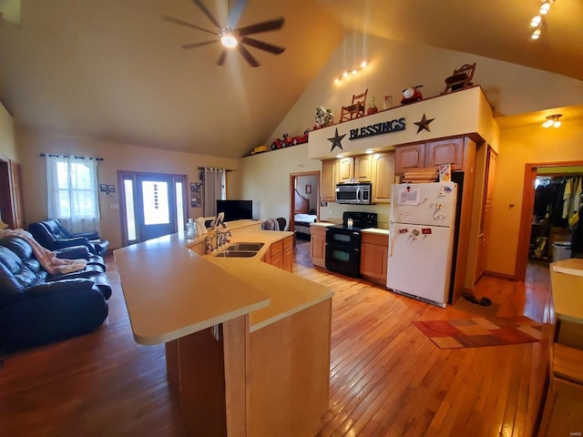 104 E Bryan St, Ewing, MO 63440 - kitchen with freestanding refrigerator, range with two ovens, stainless steel microwave, open floor plan, and a ceiling fan