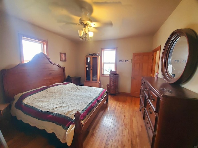 104 E Bryan St, Ewing, MO 63440 - bedroom featuring light wood-style flooring, multiple windows, and a ceiling fan
