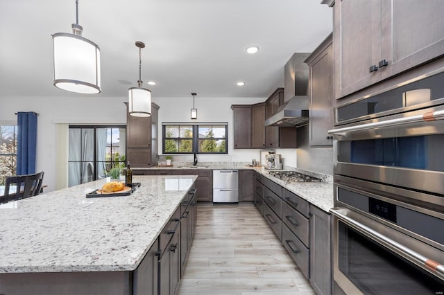 7121 Lost Oak Dr, Edwardsville, IL 62025 - kitchen with wall chimney exhaust hood, appliances with stainless steel finishes, a sink, plenty of natural light, and recessed lighting