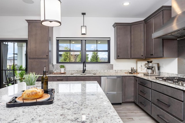 7121 Lost Oak Dr, Edwardsville, IL 62025 - kitchen with a sink, wall chimney range hood, appliances with stainless steel finishes, dark brown cabinetry, and healthy amount of natural light