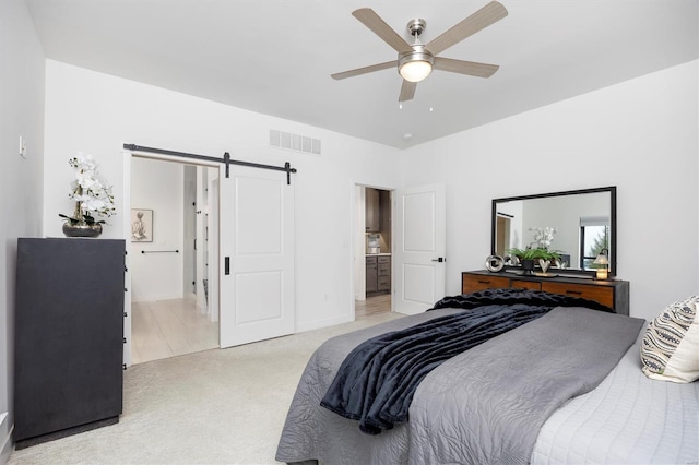 7121 Lost Oak Dr, Edwardsville, IL 62025 - bedroom featuring a barn door, light carpet, connected bathroom, ceiling fan, and baseboards