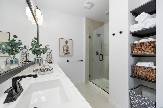 7121 Lost Oak Dr, Edwardsville, IL 62025 - bathroom with a shower stall, wood finished floors, vanity, and baseboards