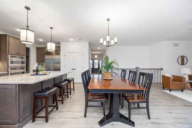 7121 Lost Oak Dr, Edwardsville, IL 62025 - dining area featuring recessed lighting, light wood finished floors, and a chandelier