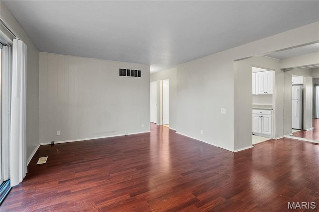 10469 Briarbend Dr Unit 4, Saint Louis, MO 63146 - unfurnished living room featuring wood finished floors and baseboards