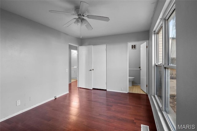 10469 Briarbend Dr Unit 4, Saint Louis, MO 63146 - unfurnished bedroom featuring wood finished floors, baseboards, ensuite bath, and ceiling fan
