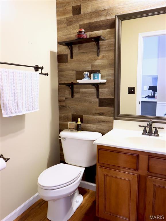 6804 Laurel Springs Ct, Fairview Heights, IL 62208 - bathroom featuring toilet, vanity, wood finished floors, and baseboards