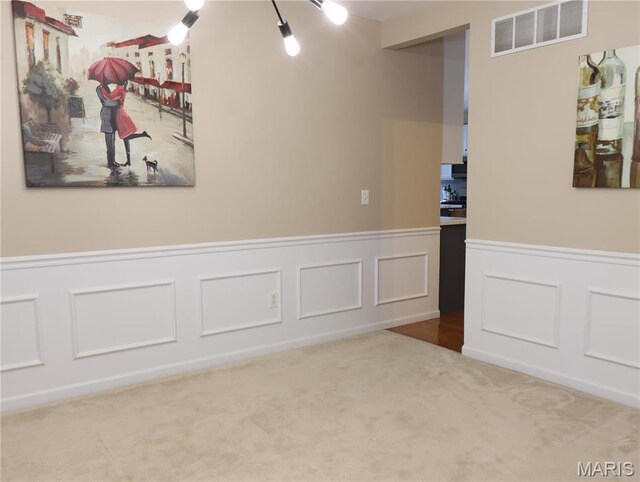 6804 Laurel Springs Ct, Fairview Heights, IL 62208 - empty room featuring carpet floors, a wainscoted wall, and a decorative wall