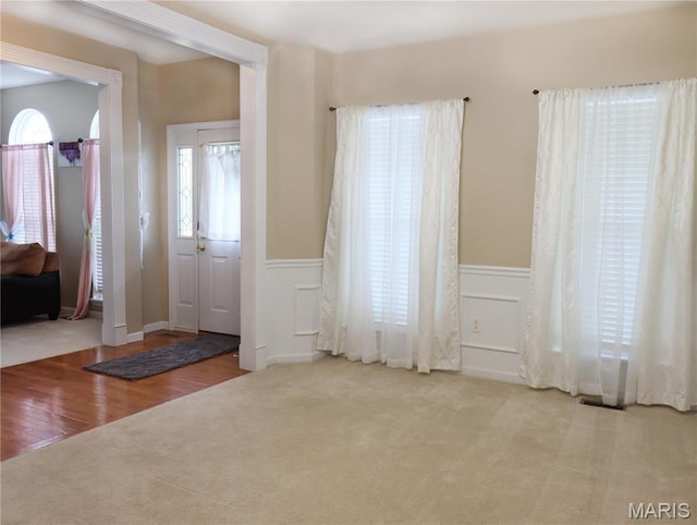 6804 Laurel Springs Ct, Fairview Heights, IL 62208 - foyer with carpet flooring, wainscoting, wood finished floors, and a decorative wall