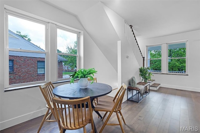 1521 Collins Ave, Saint Louis, MO 63117 - dining area featuring baseboards, vaulted ceiling, wood finished floors, and stairway