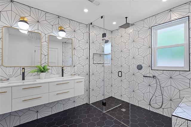 1521 Collins Ave, Saint Louis, MO 63117 - bathroom with a shower stall, double vanity, tile patterned floors, tile walls, and recessed lighting