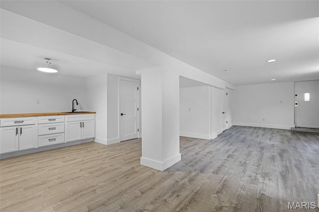 1521 Collins Ave, Saint Louis, MO 63117 - unfurnished living room featuring light wood finished floors, baseboards, and recessed lighting