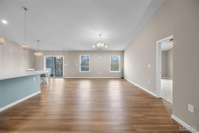 1542 Hickory Lndg, De Soto, MO 63020 - unfurnished living room with a chandelier, wood finished floors, baseboards, and recessed lighting