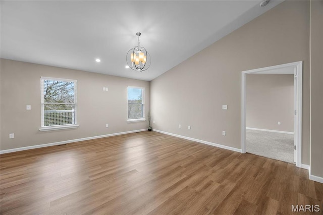 1542 Hickory Lndg, De Soto, MO 63020 - spare room with a chandelier, light wood-style floors, baseboards, vaulted ceiling, and recessed lighting