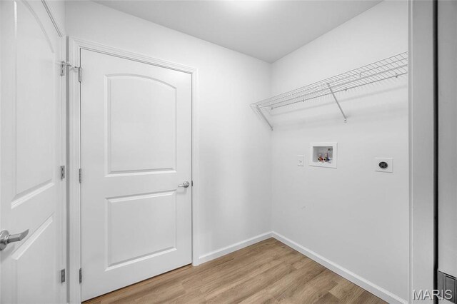 1542 Hickory Lndg, De Soto, MO 63020 - washroom with hookup for an electric dryer, hookup for a washing machine, light wood-style floors, and baseboards