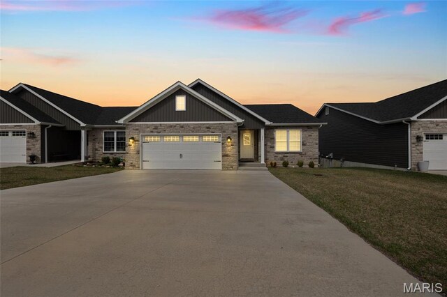 1542 Hickory Lndg, De Soto, MO 63020 - craftsman house featuring stone siding, concrete driveway, an attached garage, and a front lawn