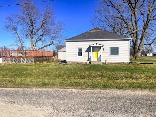 106 S 3rd, Novelty, MO 63460 - view of front of house featuring entry steps, roof with shingles, a deck, and a front lawn