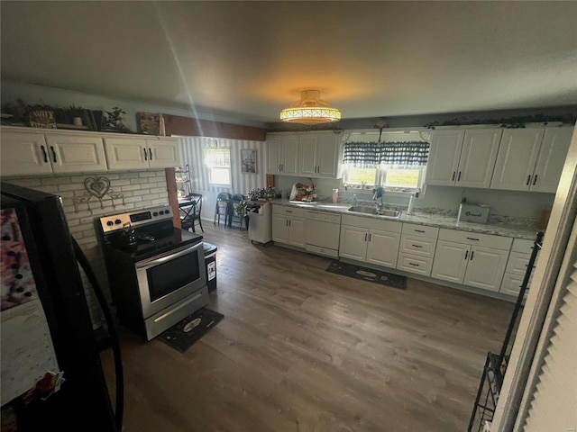 106 S 3rd, Novelty, MO 63460 - kitchen featuring stainless steel range with electric stovetop, dishwasher, a sink, and white cabinetry