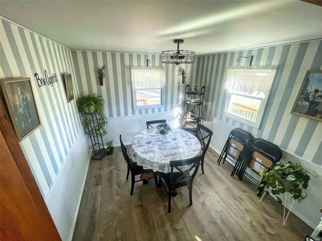 106 S 3rd, Novelty, MO 63460 - dining room with wood finished floors, a chandelier, and wallpapered walls