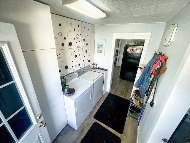 106 S 3rd, Novelty, MO 63460 - clothes washing area featuring washer and clothes dryer and wood finished floors