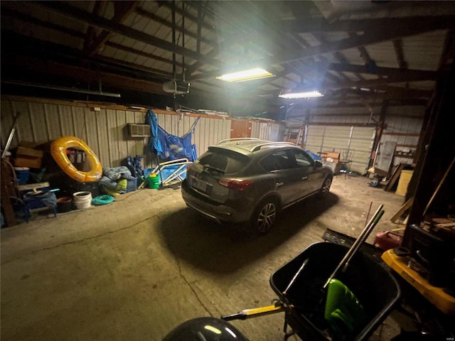 106 S 3rd, Novelty, MO 63460 - garage featuring a garage door opener and an AC wall unit