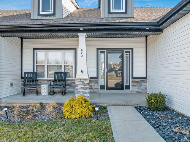 620 Lubbuck Ct, Moscow Mills, MO 63362 - entrance to property featuring a porch, roof with shingles, and stone siding